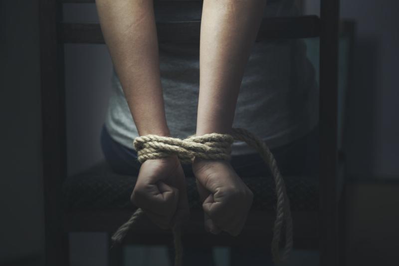 Woman,Hands,Bound,Prisoner,In,Room